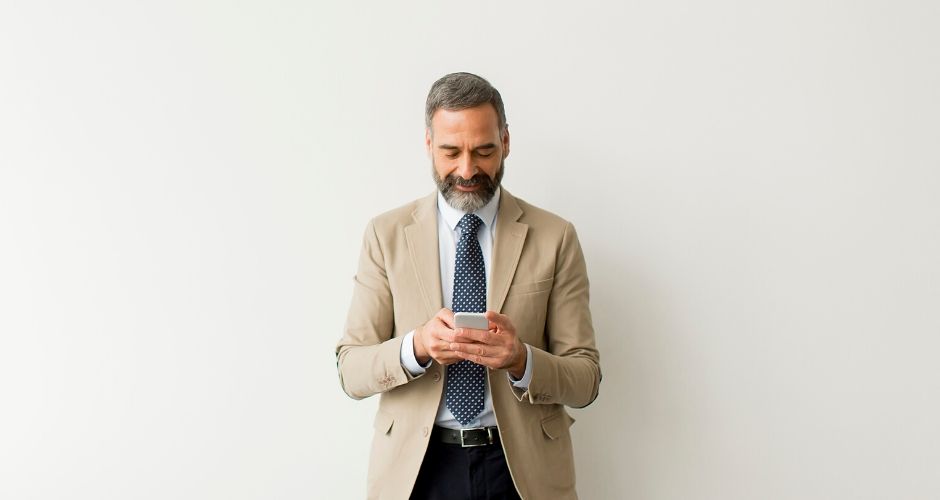 man on a cell phone reaching out to his soi